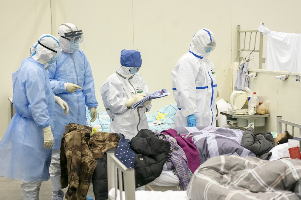 (200210) -- WUHAN, Feb. 10, 2020 (Xinhua) -- Medical staff check a patient's condition at a temporary hospital converted from 